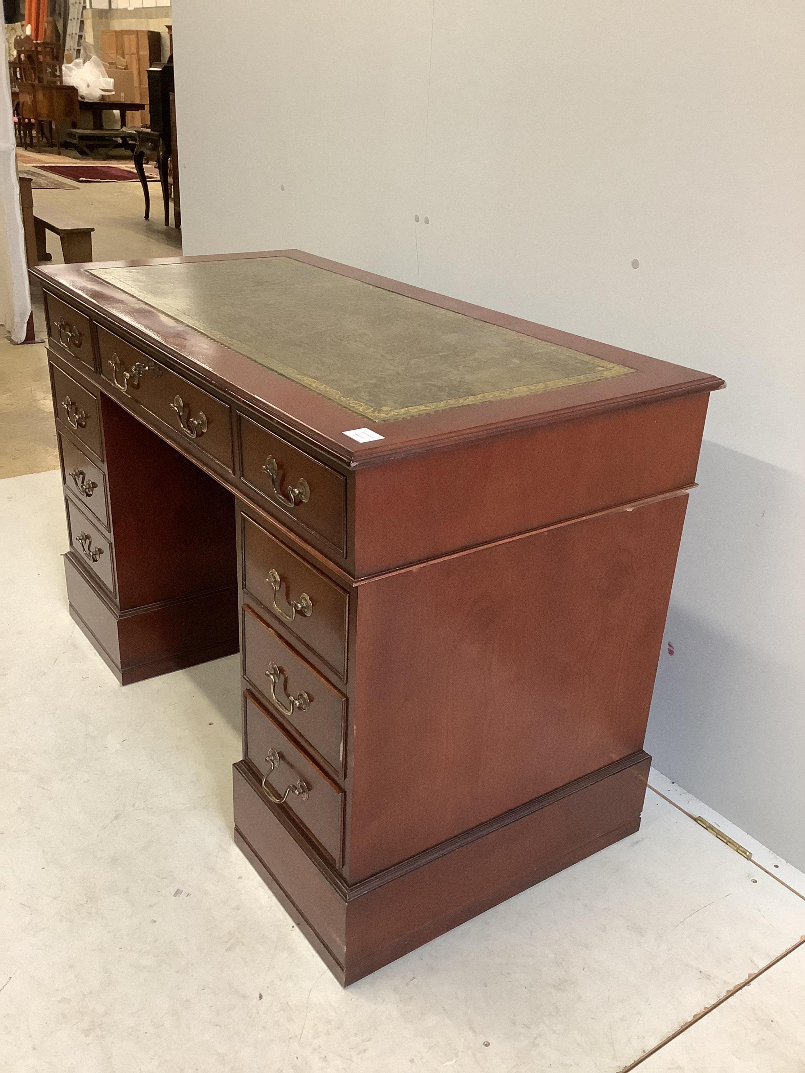 A George III style mahogany pedestal desk, fitted with nine small drawers, width 121cm, depth 60cm, height 79cm. Condition - fair to good